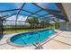 Sparkling blue pool with tropical palms, and a screened enclosure for year-round enjoyment at 25371 Paladin Ln, Punta Gorda, FL 33983