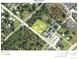 Aerial view of property in sunny area with mature trees and nearby buildings at 28024 Cleveland Ave, Punta Gorda, FL 33982