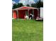 Backyard of a home featuring a covered patio area and green grass at 28024 Cleveland Ave, Punta Gorda, FL 33982