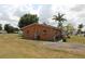 Side view of an orange home with a stone accent and a grassy yard at 28024 Cleveland Ave, Punta Gorda, FL 33982