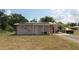 Home exterior with solar panels, stone accents, and a covered parking area on a sunny day at 28024 Cleveland Ave, Punta Gorda, FL 33982