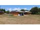 Charming home featuring a metal roof, solar panels, and a screened in porch, set within a spacious yard at 28024 Cleveland Ave, Punta Gorda, FL 33982