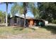 View of home's rear with an attached screened in area at 28024 Cleveland Ave, Punta Gorda, FL 33982