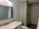 Bathroom features a shower with stone floor, neutral tile, and a modern vanity at 3300 Loveland Blvd # 602, Punta Gorda, FL 33980