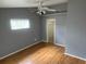 Bedroom featuring wood-look floors, a ceiling fan and light fixture, neutral paint, and a closet at 3300 Loveland Blvd # 602, Punta Gorda, FL 33980
