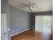 Bedroom with wood floors features a ceiling fan, neutral paint, and sliding glass doors at 3300 Loveland Blvd # 602, Punta Gorda, FL 33980