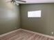 Cozy bedroom featuring wood flooring, a window, and neutral-colored walls at 3300 Loveland Blvd # 602, Punta Gorda, FL 33980