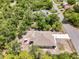 Aerial view showcases home's layout with a screened lanai, a patio with dining and proximity to a quiet neighborhood at 3322 Hampton St, Port Charlotte, FL 33948