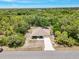 Aerial view of a home nestled among lush greenery, showcasing its spacious lot and peaceful setting at 3322 Hampton St, Port Charlotte, FL 33948