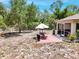 Outdoor patio with a dining set and grill, perfect for entertaining in a fenced backyard with screened lanai access at 3322 Hampton St, Port Charlotte, FL 33948