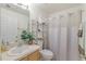 Clean bathroom featuring a single sink vanity, a toilet, and a shower with a curtain, accented by fresh towels at 3322 Hampton St, Port Charlotte, FL 33948