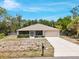 Well-maintained single-story house with a large driveway, a two-car garage, and a beautiful lawn at 3322 Hampton St, Port Charlotte, FL 33948