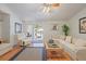 Living room featuring a comfortable sofa, hardwood floor, and access to outdoor space at 3322 Hampton St, Port Charlotte, FL 33948