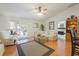 Spacious living room with hardwood floors, fan, and sliding doors to patio at 3322 Hampton St, Port Charlotte, FL 33948