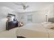 The main bedroom features a ceiling fan, neutral tones, and a dresser, creating a calm and inviting atmosphere at 3322 Hampton St, Port Charlotte, FL 33948