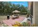 Backyard patio with a table, grill, and umbrella to keep you shaded while outdoors at 3322 Hampton St, Port Charlotte, FL 33948