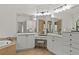 Luxury bathroom with dual vanities and a soaking tub, designed for relaxation and pampering at 3393 S Haberland Blvd, North Port, FL 34288
