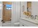 Bright bathroom featuring decorative tiling, a large vanity and a shower over the tub at 3393 S Haberland Blvd, North Port, FL 34288