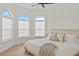 Bright bedroom featuring large windows and a comfortable king-sized bed with neutral decor at 3393 S Haberland Blvd, North Port, FL 34288