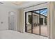Bright bedroom with a sliding glass door leading to a screened patio and outdoor grilling area at 3393 S Haberland Blvd, North Port, FL 34288