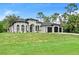Sprawling two-story home showcasing a manicured lawn and three-car garage at 3393 S Haberland Blvd, North Port, FL 34288