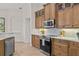 Beautiful kitchen featuring wood cabinets, stainless steel appliances, and subway tile backsplash at 3393 S Haberland Blvd, North Port, FL 34288