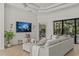 Bright living room showcases tile flooring, stylish furniture, and outdoor views at 3393 S Haberland Blvd, North Port, FL 34288