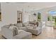 Spacious living room featuring an oversized sectional sofa, arched doorway, and elegant dining area at 3393 S Haberland Blvd, North Port, FL 34288