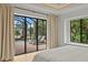 Serene main bedroom with sliding doors to the pool, creating a seamless indoor-outdoor living experience at 3393 S Haberland Blvd, North Port, FL 34288