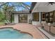 Inviting pool area with lounge chairs and a covered patio, designed for ultimate outdoor relaxation at 3393 S Haberland Blvd, North Port, FL 34288