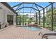 Screened-in pool and patio featuring a waterfall, providing a private and relaxing outdoor retreat at 3393 S Haberland Blvd, North Port, FL 34288
