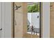 Modern shower with designer tile, glass door, and a view of the outdoor greenery at 3393 S Haberland Blvd, North Port, FL 34288