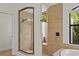 Modern bathroom featuring a glass-enclosed shower and a separate window offering natural light at 3393 S Haberland Blvd, North Port, FL 34288