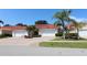Charming villa with brick paved driveway and two-car garage, surrounded by lush landscaping and sunny skies at 3803 Albacete Cir # 64, Punta Gorda, FL 33950