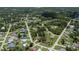 A birds-eye view showcases the home's layout with generous landscaping in a lush neighborhood at 3960 Magara Ter, North Port, FL 34287