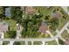 Aerial view of a property with a backyard pool, mature trees, and a private, landscaped lawn at 3960 Magara Ter, North Port, FL 34287