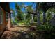 Secluded backyard with lush greenery, stepping stones, and a seating area at 3960 Magara Ter, North Port, FL 34287