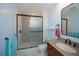 Updated bathroom featuring a walk-in shower with decorative black and white tile at 3960 Magara Ter, North Port, FL 34287