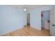Spacious bedroom with hardwood floors, light blue walls, and a ceiling fan at 3960 Magara Ter, North Port, FL 34287