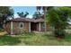 Inviting home exterior with lush landscaping, arched windows, and a charming front porch at 3960 Magara Ter, North Port, FL 34287
