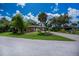 Charming single-story home with a well-manicured front yard, mature trees, and a circular driveway at 3960 Magara Ter, North Port, FL 34287