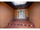 Covered front porch with tile flooring and colorful accents at 3960 Magara Ter, North Port, FL 34287