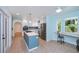 Updated kitchen featuring stainless steel appliances, white cabinets, a kitchen island and breakfast nook with a view at 3960 Magara Ter, North Port, FL 34287