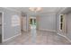 Spacious living room with tile floors, modern lighting, and sliding glass doors to the pool at 3960 Magara Ter, North Port, FL 34287