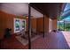 Covered patio with red brick flooring, ceiling fan, neutral paint, and outdoor seating area at 3960 Magara Ter, North Port, FL 34287
