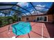 Backyard pool with screened enclosure, tile deck, lounge chairs, and well-maintained landscaping at 3960 Magara Ter, North Port, FL 34287