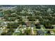 Aerial view of a residential neighborhood with tree-lined streets and well-maintained homes at 4294 Wooley Ave, North Port, FL 34287