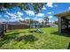 Backyard with a well-kept lawn, complete with a playground, offers ample space for outdoor activities at 4294 Wooley Ave, North Port, FL 34287