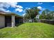 Expansive backyard features a covered lanai and a play area, ideal for relaxation and entertainment at 4294 Wooley Ave, North Port, FL 34287