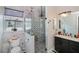 The bathroom features a glass shower, marble countertop, modern fixtures and natural light from the window at 4294 Wooley Ave, North Port, FL 34287